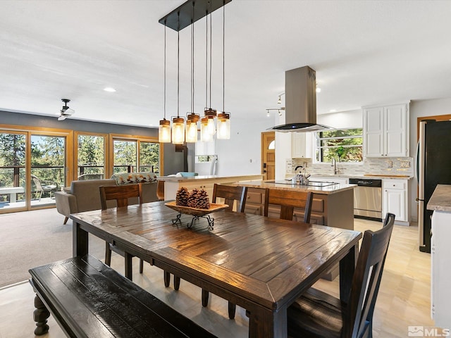 dining room featuring ceiling fan, light hardwood / wood-style flooring, and sink