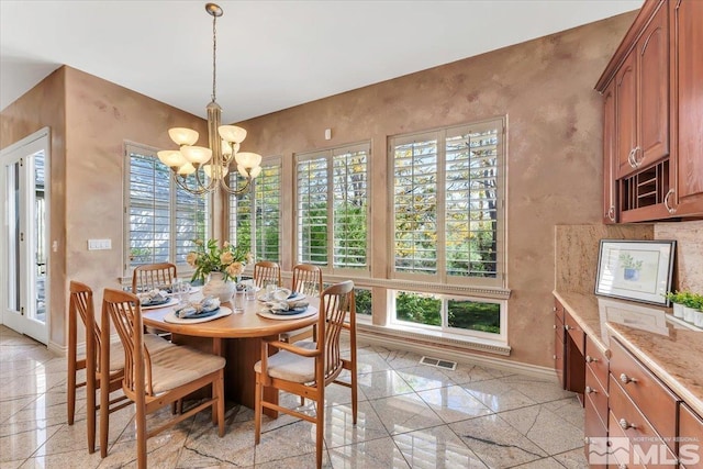 dining room featuring a chandelier and a healthy amount of sunlight