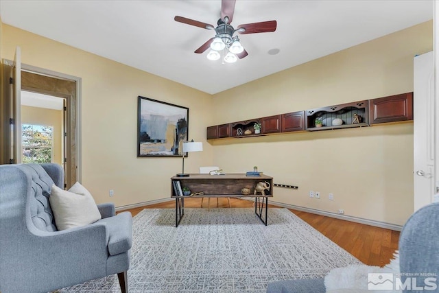 office space featuring ceiling fan and light wood-type flooring