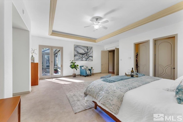 bedroom with access to outside, a tray ceiling, ceiling fan, and light colored carpet