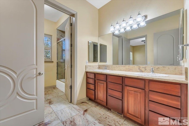 bathroom featuring vanity and combined bath / shower with glass door