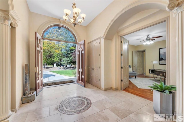 entrance foyer featuring light hardwood / wood-style flooring and ceiling fan with notable chandelier