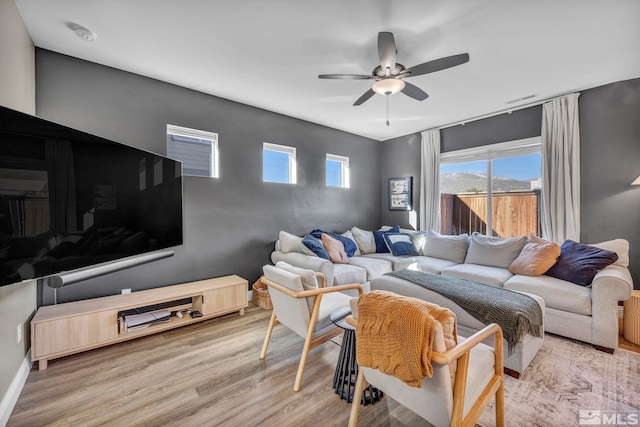 living room featuring light hardwood / wood-style floors and ceiling fan