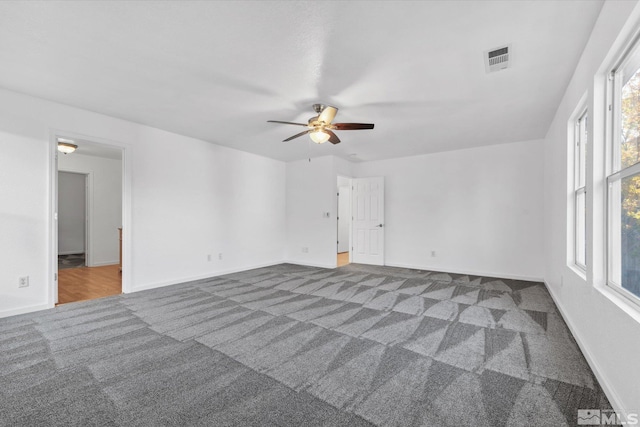 unfurnished room with ceiling fan and carpet flooring