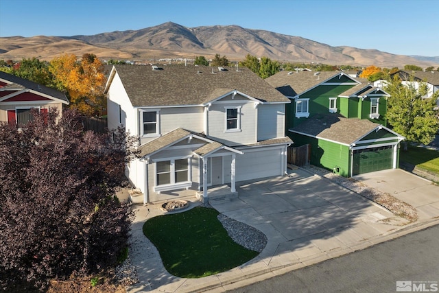 view of front of home with a mountain view and a garage