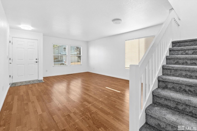 entryway featuring a textured ceiling and hardwood / wood-style floors