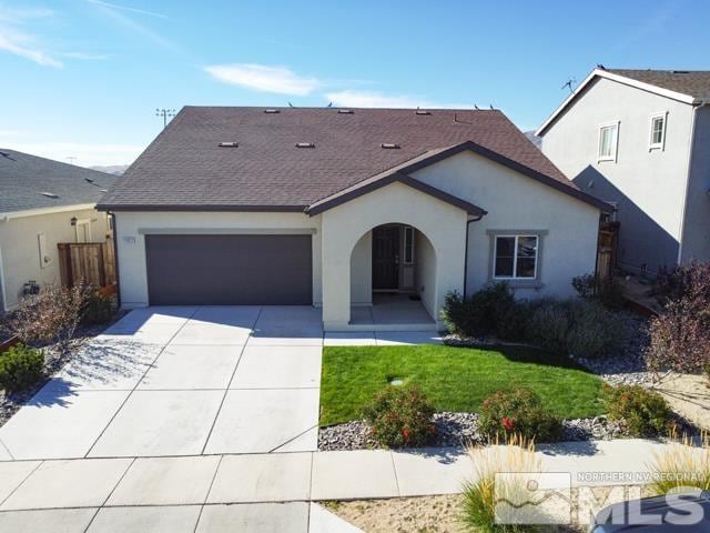 view of front of house featuring a garage and a front lawn