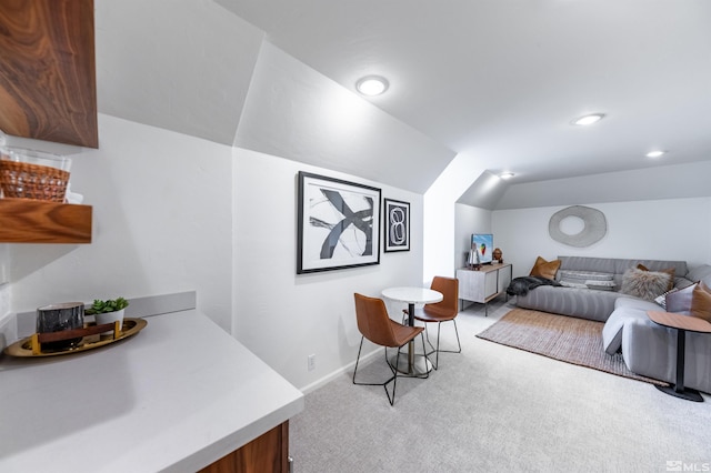 interior space with lofted ceiling and light colored carpet