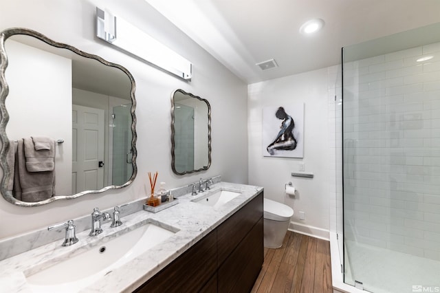 bathroom with vanity, an enclosed shower, hardwood / wood-style floors, and toilet