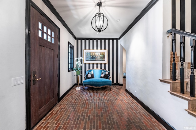 entrance foyer featuring crown molding and a notable chandelier