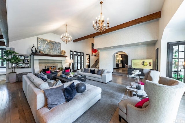 living room with beam ceiling, an inviting chandelier, dark wood-type flooring, and high vaulted ceiling