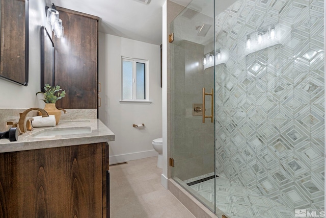 bathroom with a shower with shower door, vanity, and toilet