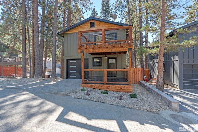 view of front of home featuring a balcony and a garage