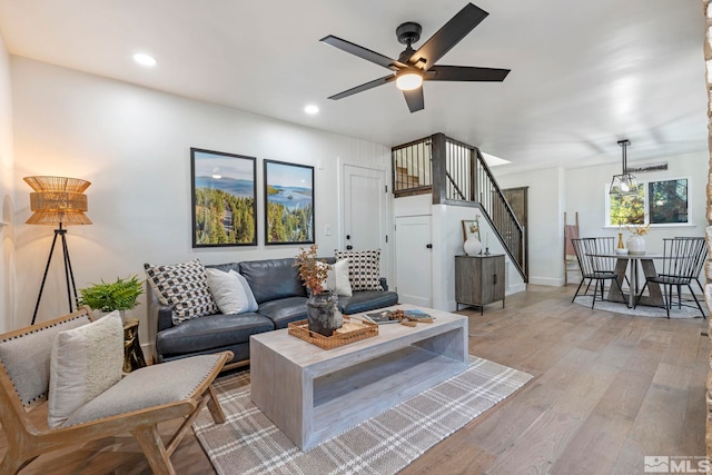 living room with ceiling fan and light hardwood / wood-style floors