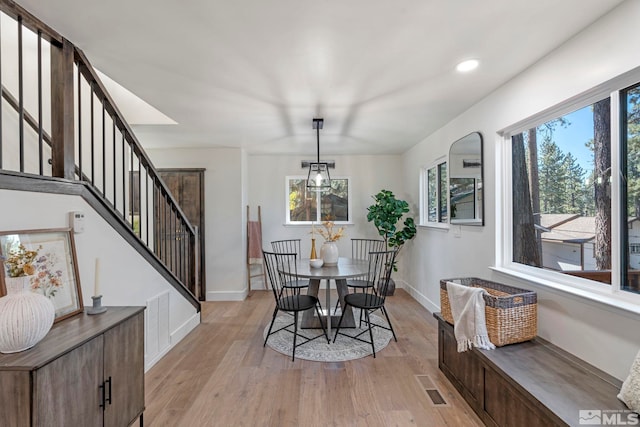 dining space with light hardwood / wood-style flooring and plenty of natural light