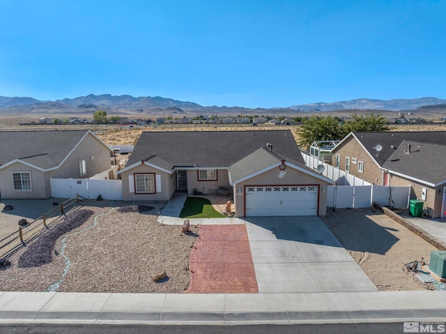 single story home featuring a mountain view and a garage