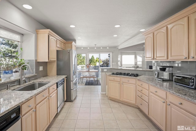 kitchen featuring light tile patterned flooring, sink, backsplash, light brown cabinets, and appliances with stainless steel finishes