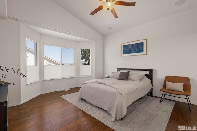 bedroom featuring ceiling fan, dark wood-type flooring, and vaulted ceiling