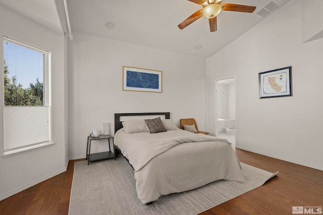 bedroom with vaulted ceiling, ceiling fan, ensuite bathroom, and dark hardwood / wood-style flooring