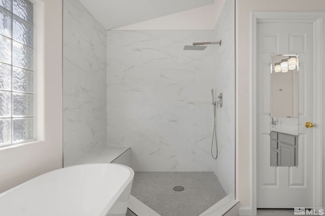 bathroom with lofted ceiling, vanity, and separate shower and tub