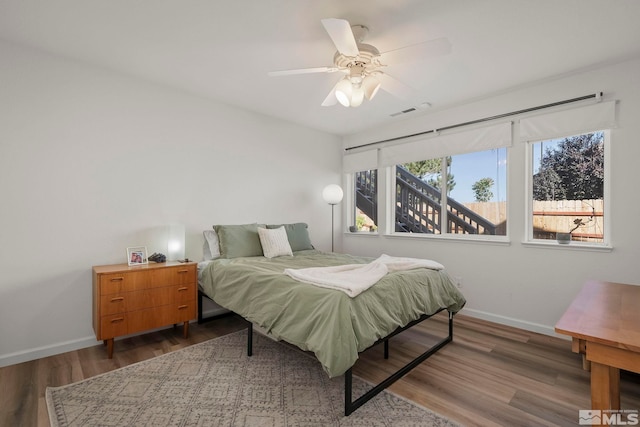 bedroom with wood-type flooring and ceiling fan