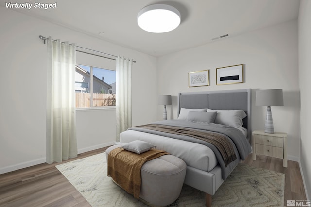 bedroom with wood-type flooring