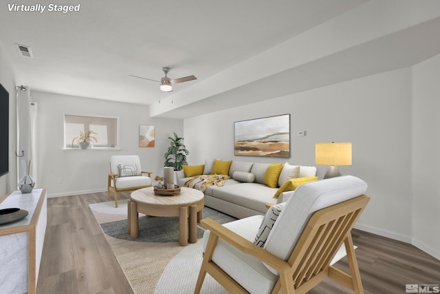 living room featuring ceiling fan and hardwood / wood-style flooring