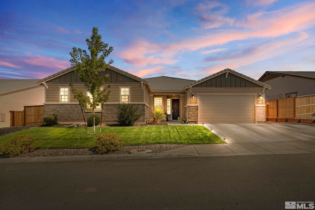 view of front of home with a yard and a garage