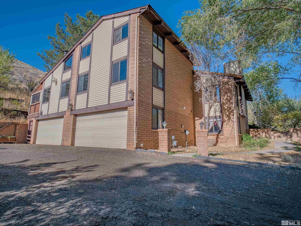 view of side of home featuring a garage