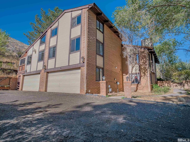 view of side of home featuring a garage