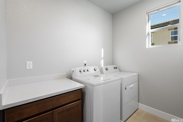 laundry room with washing machine and clothes dryer and light tile patterned floors