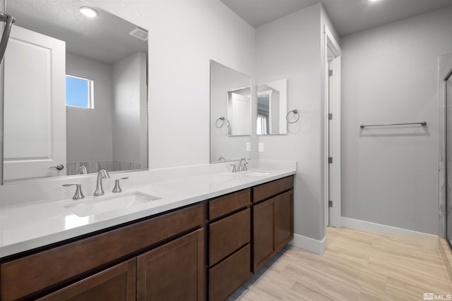 bathroom featuring vanity, a textured ceiling, and hardwood / wood-style flooring