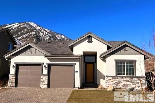 view of front of house featuring a mountain view and a garage