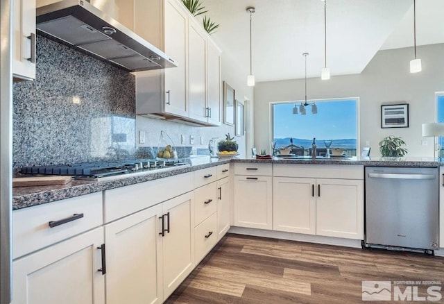 kitchen featuring pendant lighting, wall chimney range hood, white cabinetry, dishwasher, and dark hardwood / wood-style floors