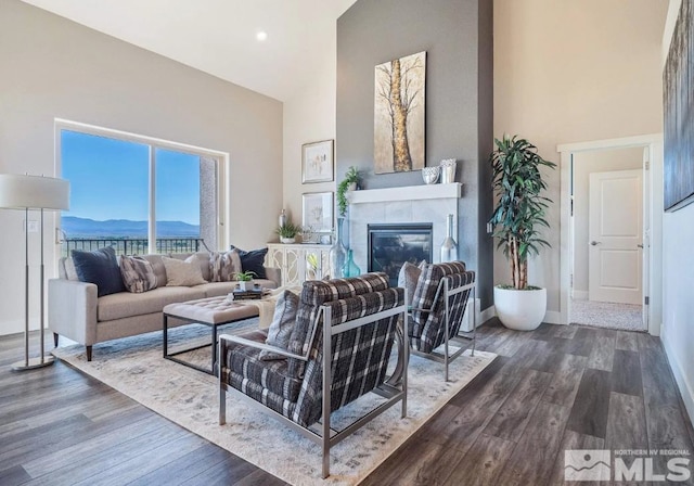 living room featuring a high ceiling, a mountain view, and dark hardwood / wood-style floors