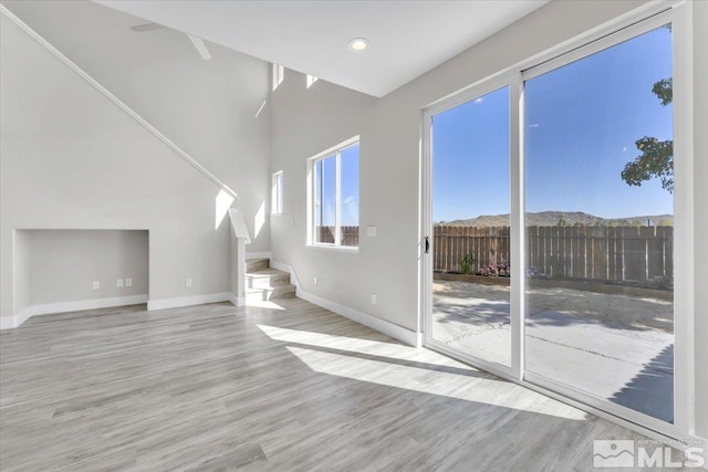 unfurnished living room featuring light wood-type flooring