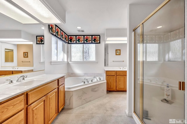 bathroom with vanity and separate shower and tub