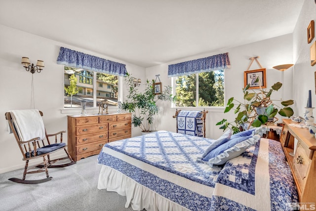 bedroom featuring carpet and multiple windows