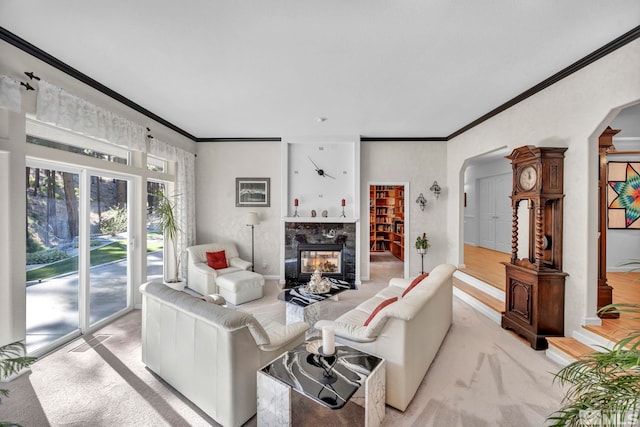 carpeted living room with a tile fireplace and crown molding