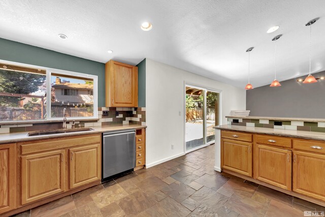 kitchen with decorative backsplash, decorative light fixtures, sink, dishwasher, and a textured ceiling