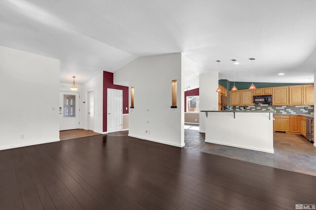 unfurnished living room featuring beverage cooler, vaulted ceiling, and wood-type flooring