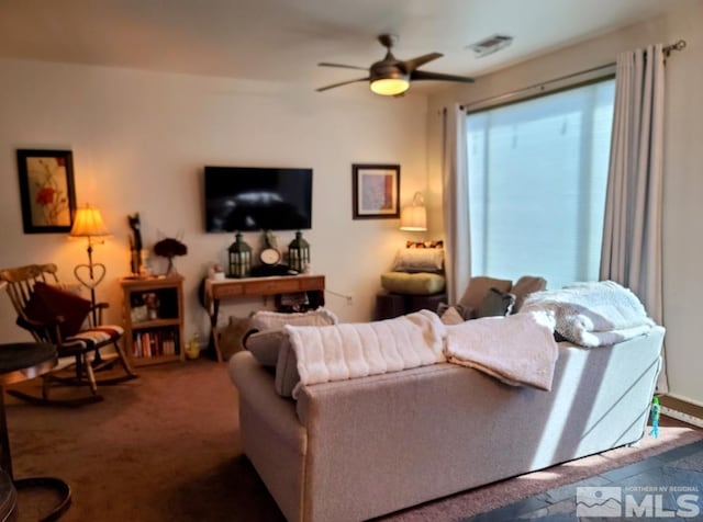 living room with ceiling fan and carpet floors