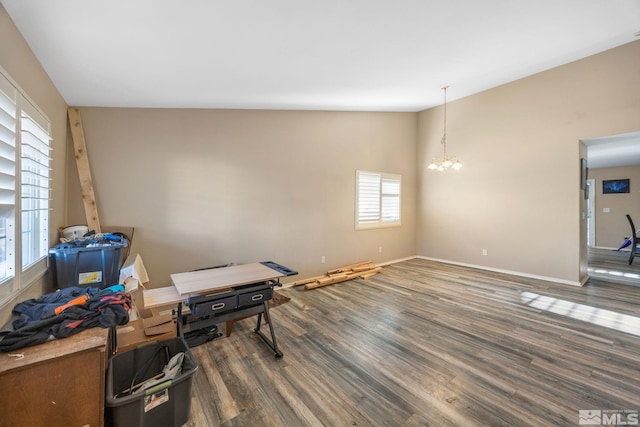 interior space with an inviting chandelier, high vaulted ceiling, and dark hardwood / wood-style floors