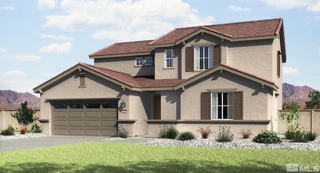 view of front of home featuring a mountain view, a garage, and a front lawn