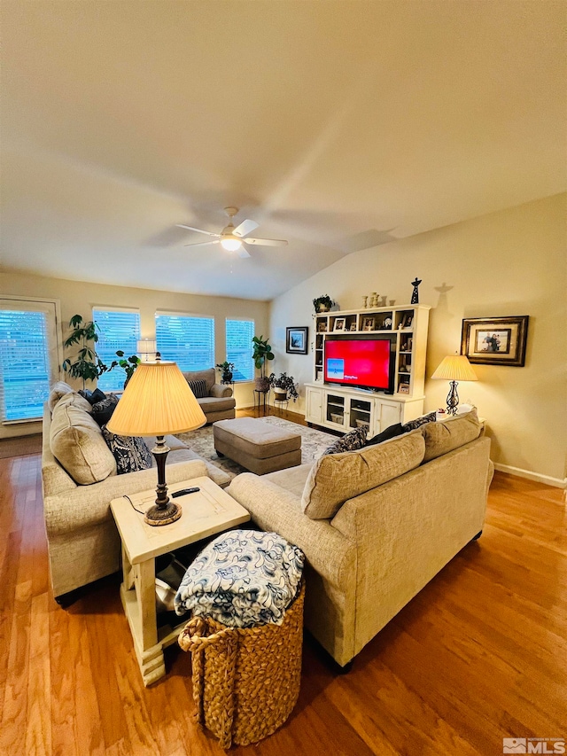 living room with lofted ceiling, ceiling fan, and hardwood / wood-style flooring