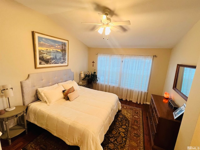 bedroom featuring vaulted ceiling, dark hardwood / wood-style floors, and ceiling fan