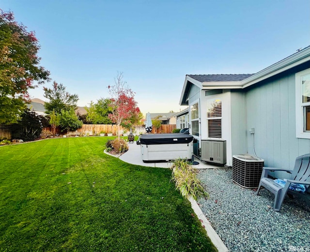 view of yard with cooling unit, a patio area, and a hot tub