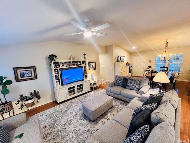 living room featuring ceiling fan with notable chandelier, lofted ceiling, and hardwood / wood-style flooring