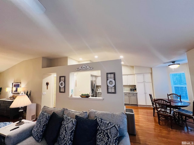 living room featuring hardwood / wood-style flooring and vaulted ceiling