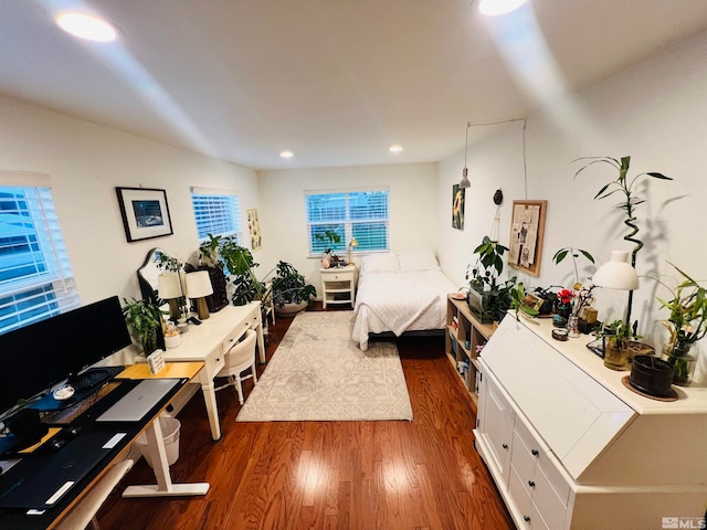 bedroom with multiple windows and dark hardwood / wood-style flooring